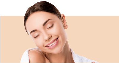 Close up of a young woman's face. She is smiling with her eyes closed.
